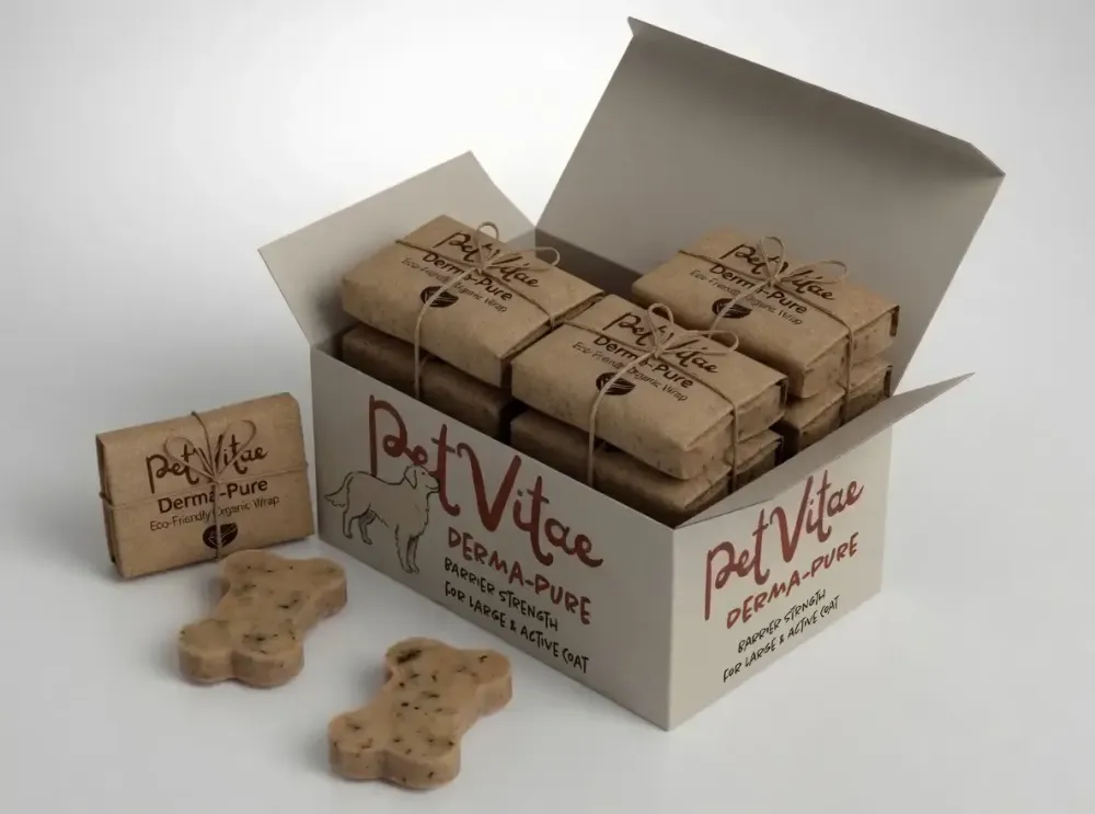A box of Derma-Pure for larger breeds sat on a white table with open lead, so the smaller wrapped contents can be seen, with a couple of chews open on the table